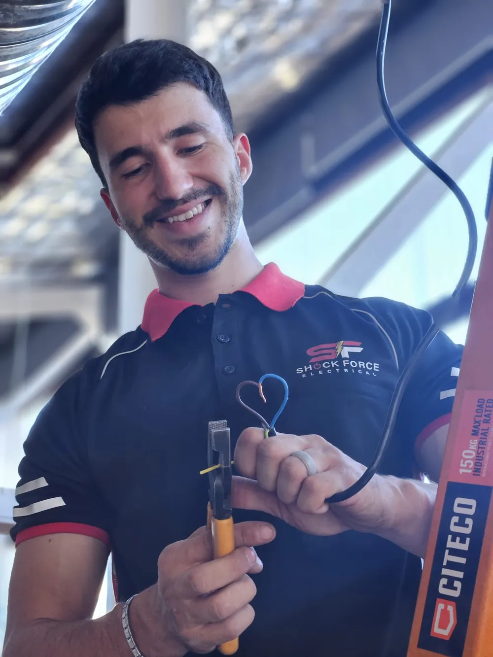 Shock Force electrician preparing cable on site