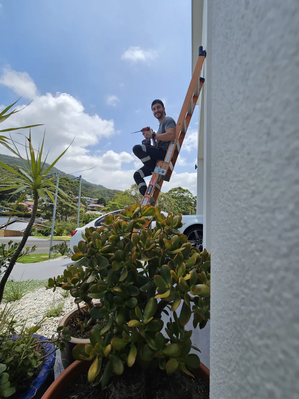 Shock Force electrician working from a ladder